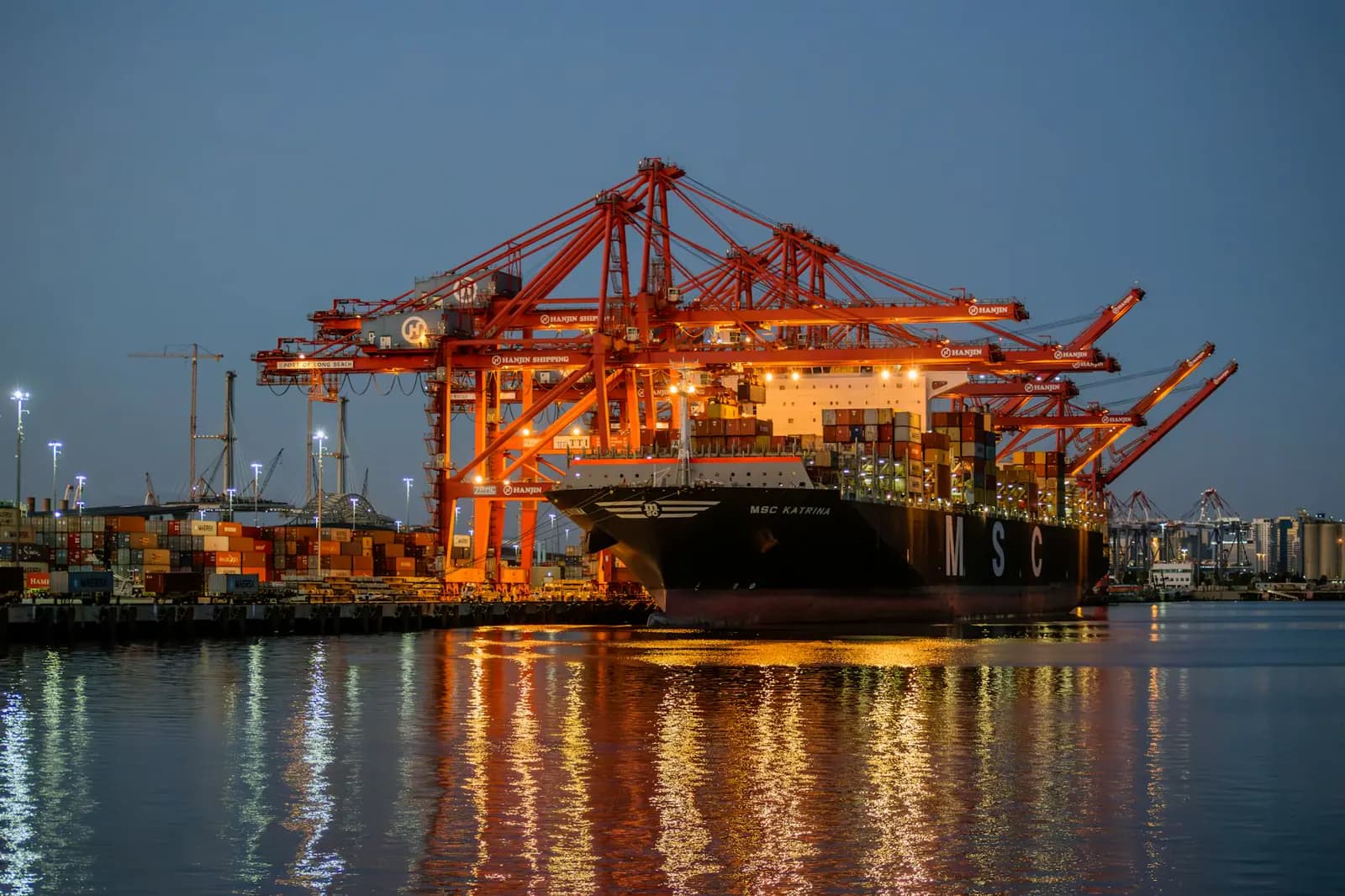 Container ship and port infrastructure at night